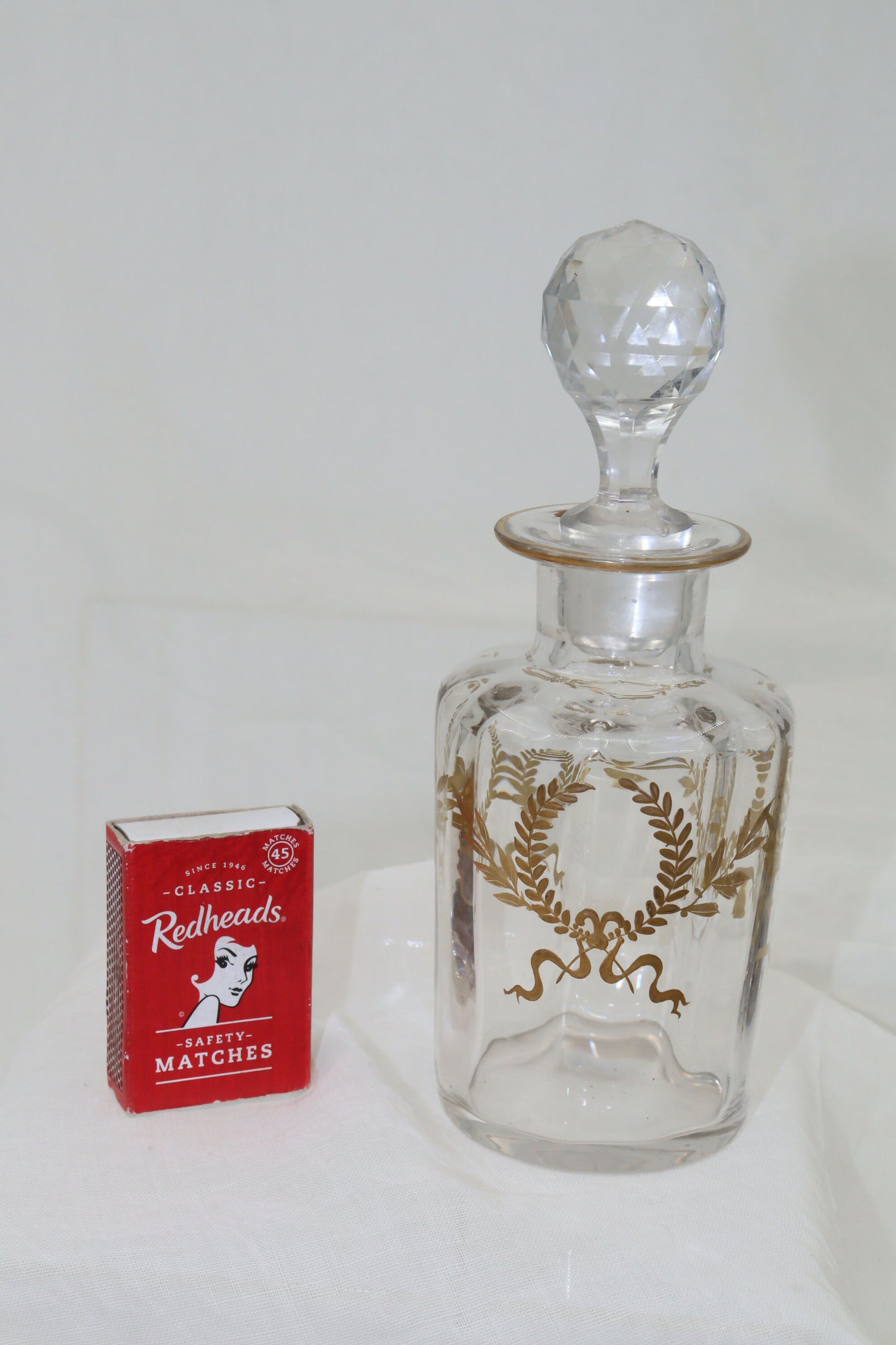 Glass perfume bottle with gilt laurel wreaths