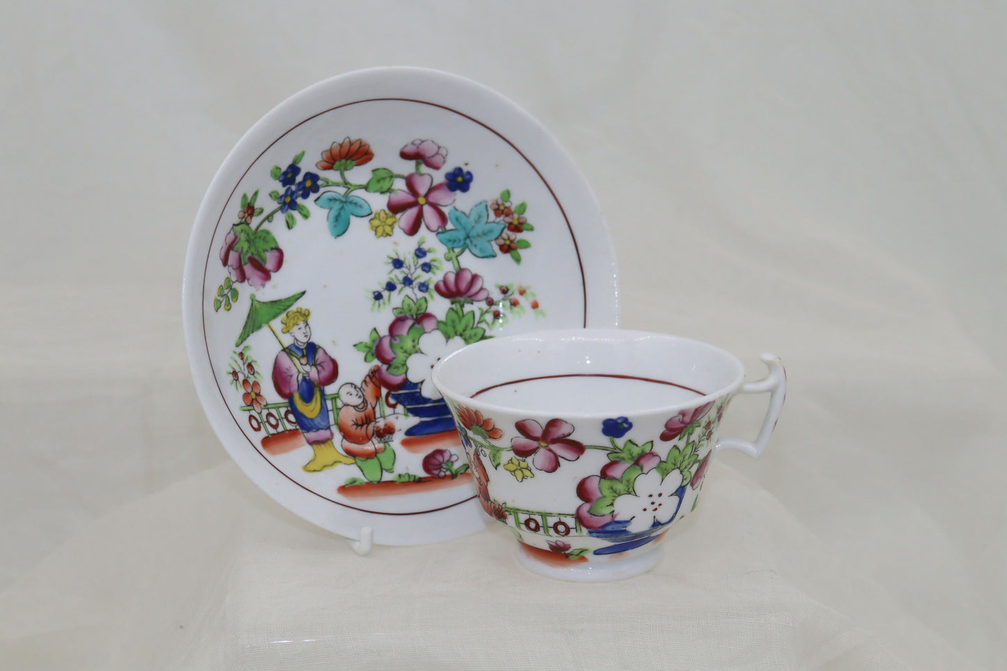 Set of four hand coloured cups and saucers by Hilditch